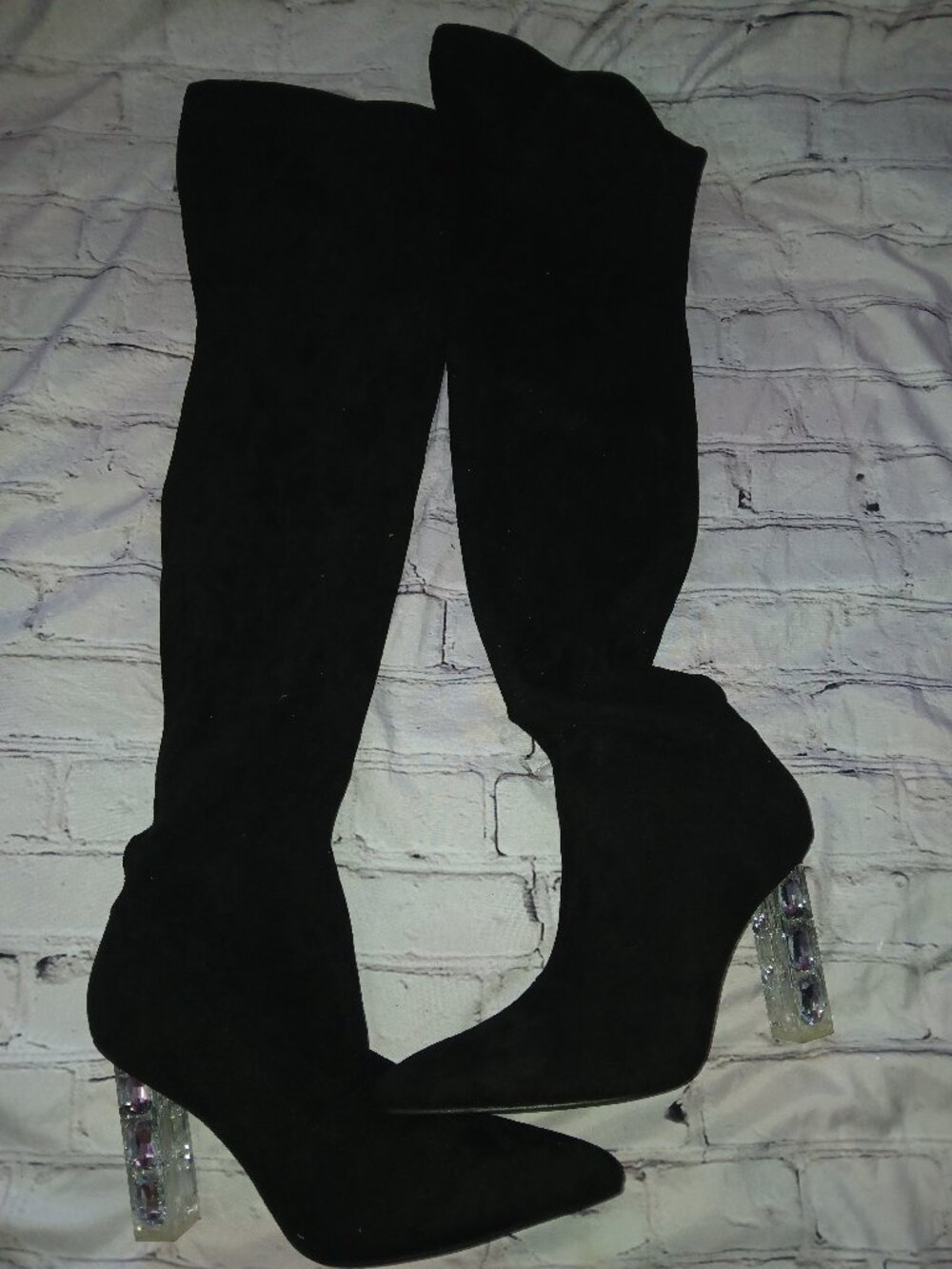 Black suede knee-high boots with crystal heel